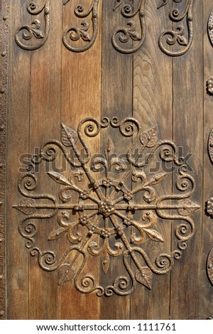 Ornamental ironwork on old oak door