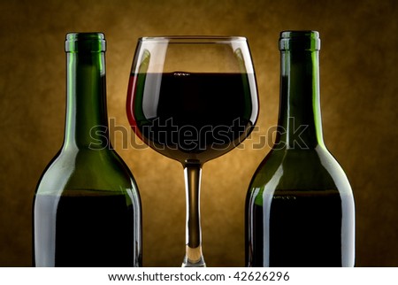 Wine glass and two wine bottles