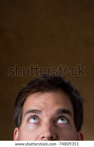 Close up of a mans face looking upward into empty type space