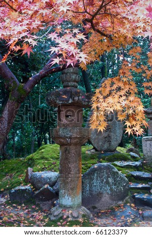 Stone lantern and colorful fall foliage at a Japanese temple