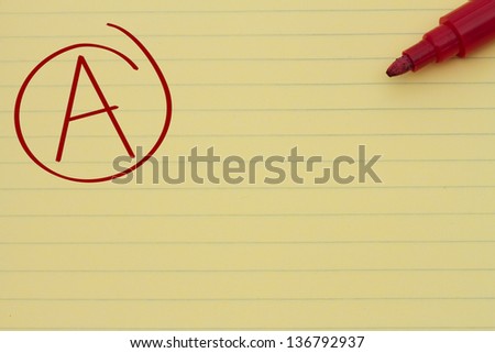 Yellow Lined Paper with the grade A in red circled and a marker, Getting a great grade