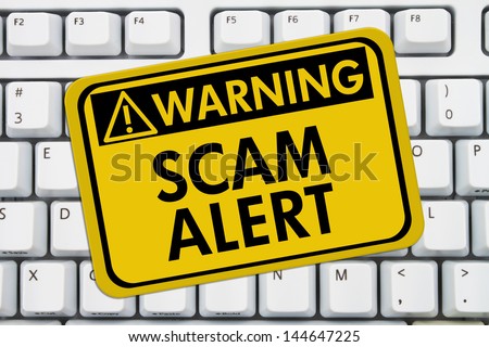 Computer keyboard keys with warning sign with words Scam Alert, Scam Alert
