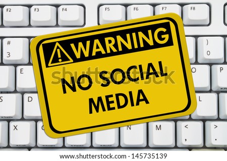 Computer keyboard keys with warning sign with words No Social Media, No accessing social media at work