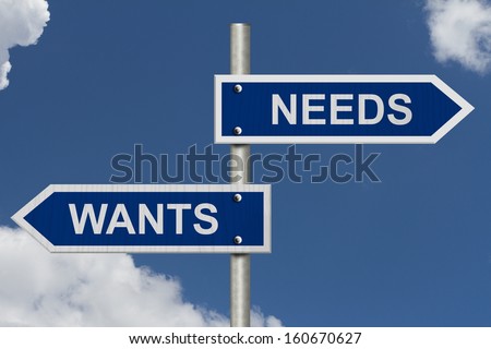 A blue street sign with blue sky with words Wants and Needs, Wants versus Needs
