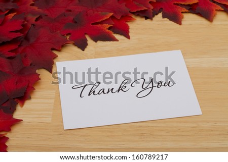 Red Autumn Leaves Background with wooden center and a Thank You card, Thank You