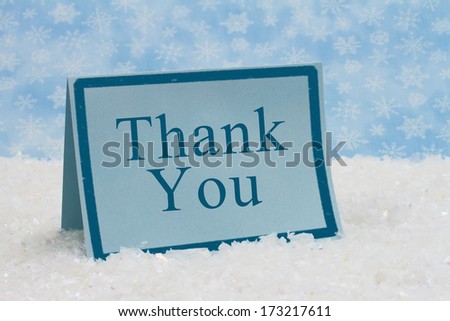 A blue blank card on snow and a blue snowflake background with text of Thank You, Thank You Message