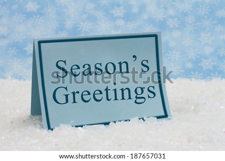 Season\'s Greetings Message,A blue blank card on snow and a blue snowflake background with text of Season\'s Greetings