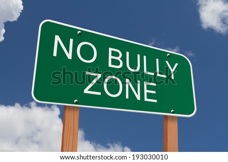 No Bully Zone Sign, Green highway sign with words No Bully Zone with blue sky background