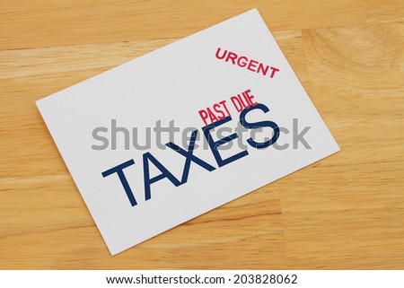 Taxes Past Due envelop with past due and urgent stamps on a wooden desk