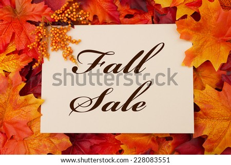 A Fall Sale card, A beige card with words Fall Sale over red and orange maple leaf background