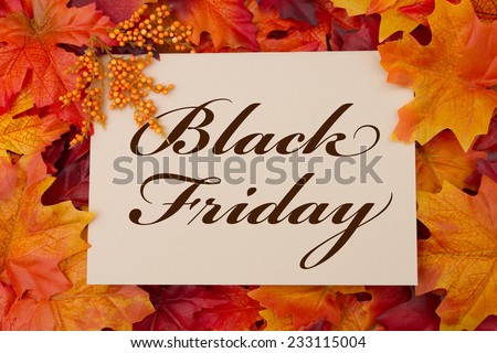 A Black Friday card, A beige card with words Black Friday over red and orange maple leaf background