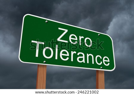 Zero Tolerance Sign, Green highway sign with words Zero Tolerance with stormy sky background