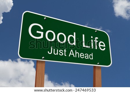 Good Life Just Ahead Sign, Green highway sign with words Good Life Just Ahead with sky background