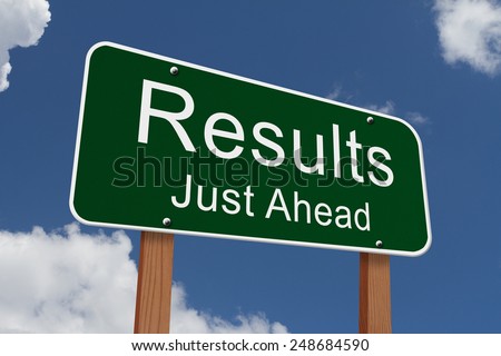 Results Just Ahead Sign, Green highway sign with words Results Just Ahead with sky background