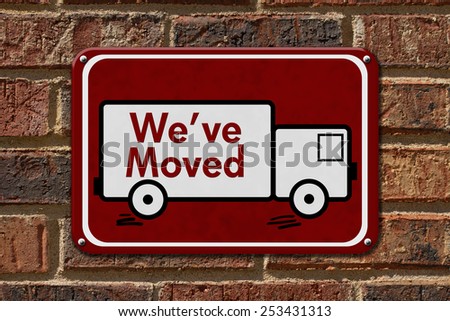 We have Moved Sign,  A red sign with the word We\'ve Moved with a truck on a brick wall