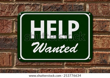 Help Wanted Sign,  A green sign with the word Help Wanted with an arrow on a brick wall