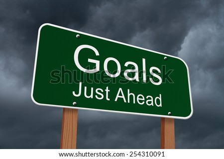 Goals Just Ahead Sign, Green highway sign with words Goals Just Ahead with stormy sky background