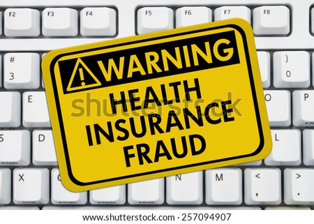 Health Insurance Fraud Warning Sign,  A yellow sign with the words Health Insurance Fraud on a keyboard