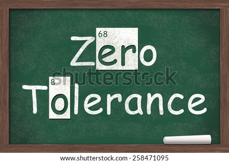 Zero Tolerance, Zero Tolerance written on a chalkboard with letters from the periodic table and a piece of white chalk