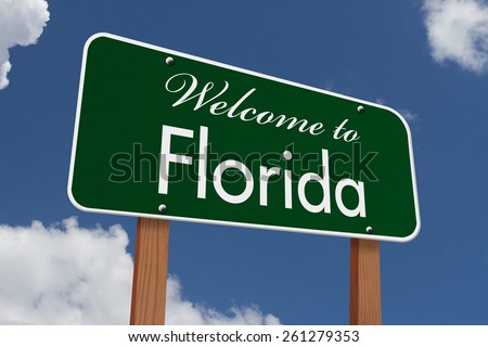 Welcome to Florida Road Sign, Green highway sign with words Welcome to Florida with sky background
