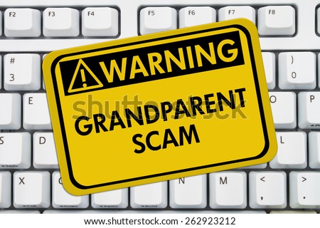 Grandparent Scam Warning Sign,  A yellow sign with the words Grandparent Scam on a keyboard