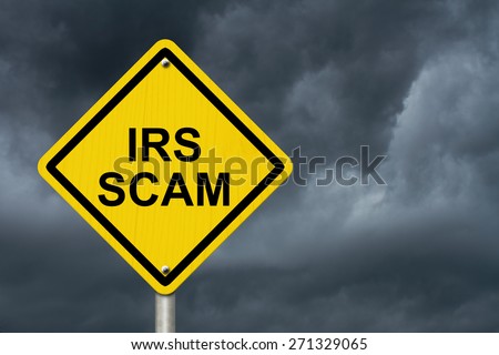 IRS Scam Warning Sign, Yellow warning road sign with word IRS Scam with stormy sky background