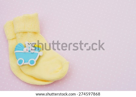 Yellow Baby Background, Pink baby socks with baby toy on pink and white polka dot background with copy-space for your message