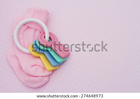 Pink Baby Background, Pink baby socks with soother in pink and white polka dot background with copy-space for your message