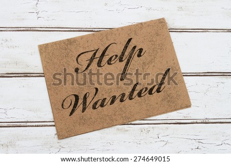 A Help Wanted Card, A brown card with words Welcome over a distressed wood background