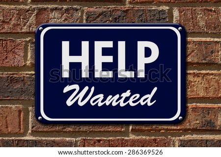 Help Wanted Sign,  A blue sign with the word Help Wanted with an arrow on a brick wall