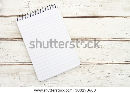 Blank Notepad for your message, A spiral Notepad that is blank over a distressed wood background