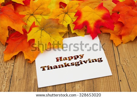 Happy Thanksgiving, Autumn Leaves on weathered grunge wood with a Happy Thanksgiving Card