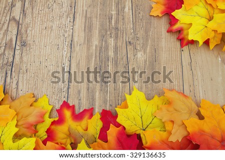Autumn Leaves and Weathered Wood Background, Autumn Leaves on Weathered Grunge Wood with space for your message