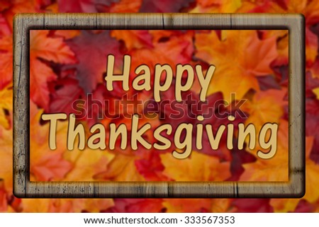 Happy Thanksgiving Greeting, Fall Leaves Background with Wood Frame and text Happy Thanksgiving