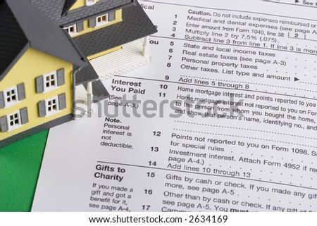 federal income tax form with colorful yellow house - mortgage interest deduction