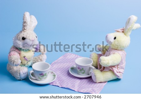 male and female stuffed bunnies having a tea party