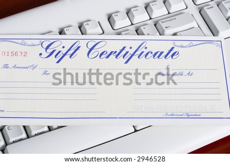 close-up of a computer white keyboard with gift certificate - online shopping