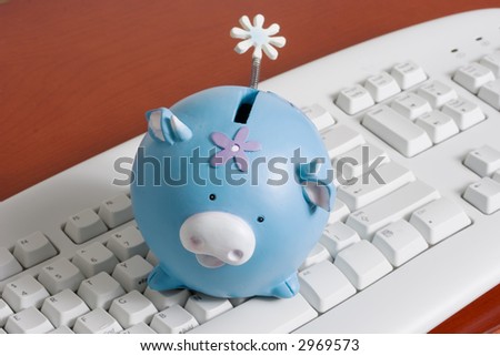 close-up of a computer white keyboard with piggy bank - online shopping