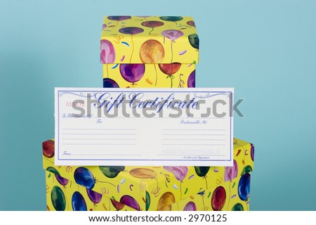 Two colorful gift boxes with balloon decoration with a gift certificate