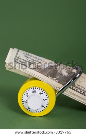 Yellow combination lock with twenty dollar bills
