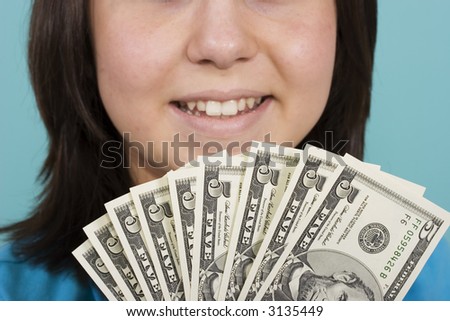 A women holding a lot of five dollar bills