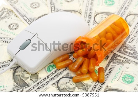a computer mouse with pills and money background - computerized healthcare