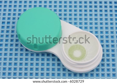 Colored Contact lens case on blue textured background