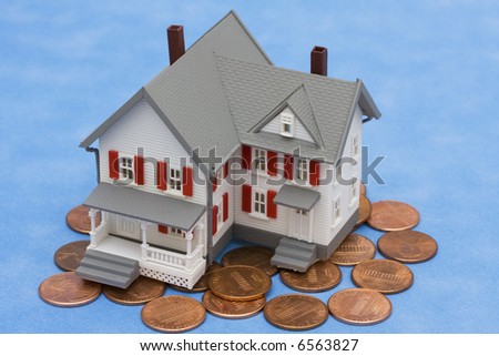 House sitting on pennies with blue background