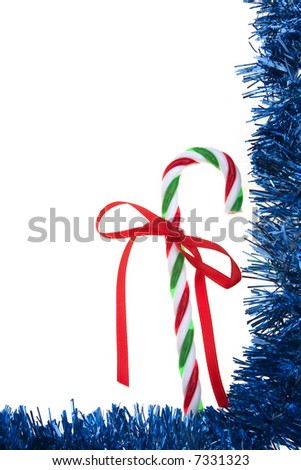 Blue garland frame with candy cane isolated on white