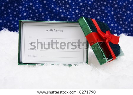 Blank gift card in box on snow with star background