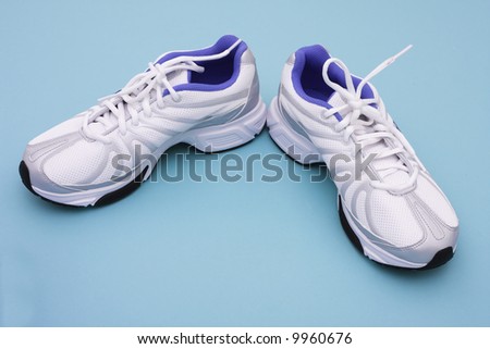 Athletic shoes on blue background with copy space