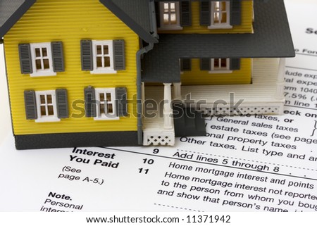 House with money and tax paper – us schedule A form
