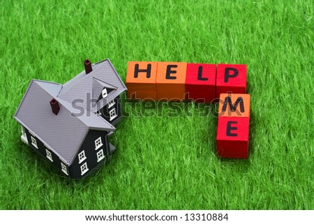 House with alphabet blocks spelling help me