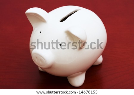Piggy bank on a red background with copy space